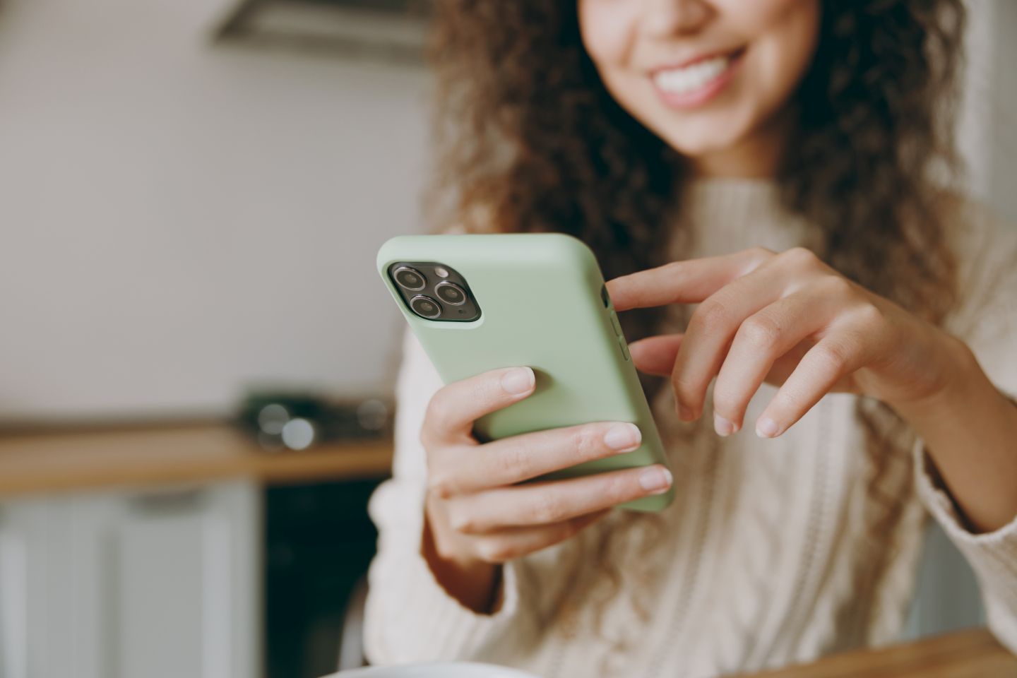 Smiling woman looking at device screen